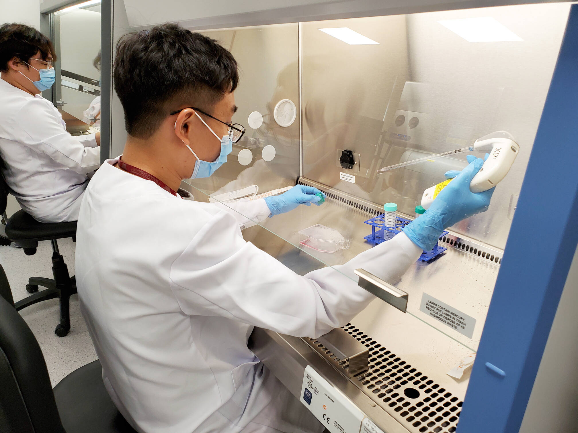 A researcher pipetting samples.